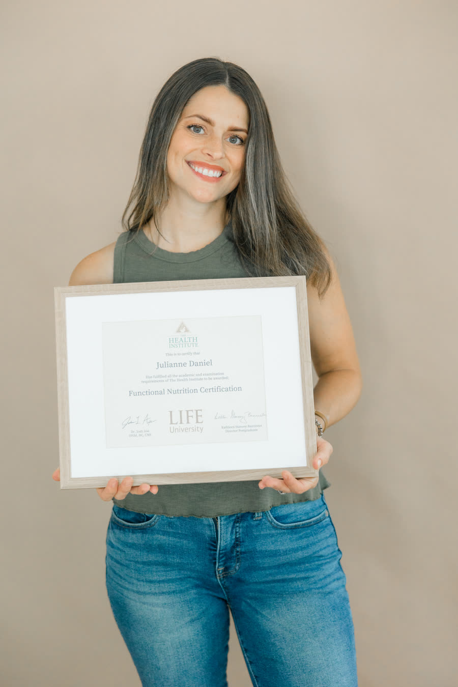Julianne holding her functional nutrition certification