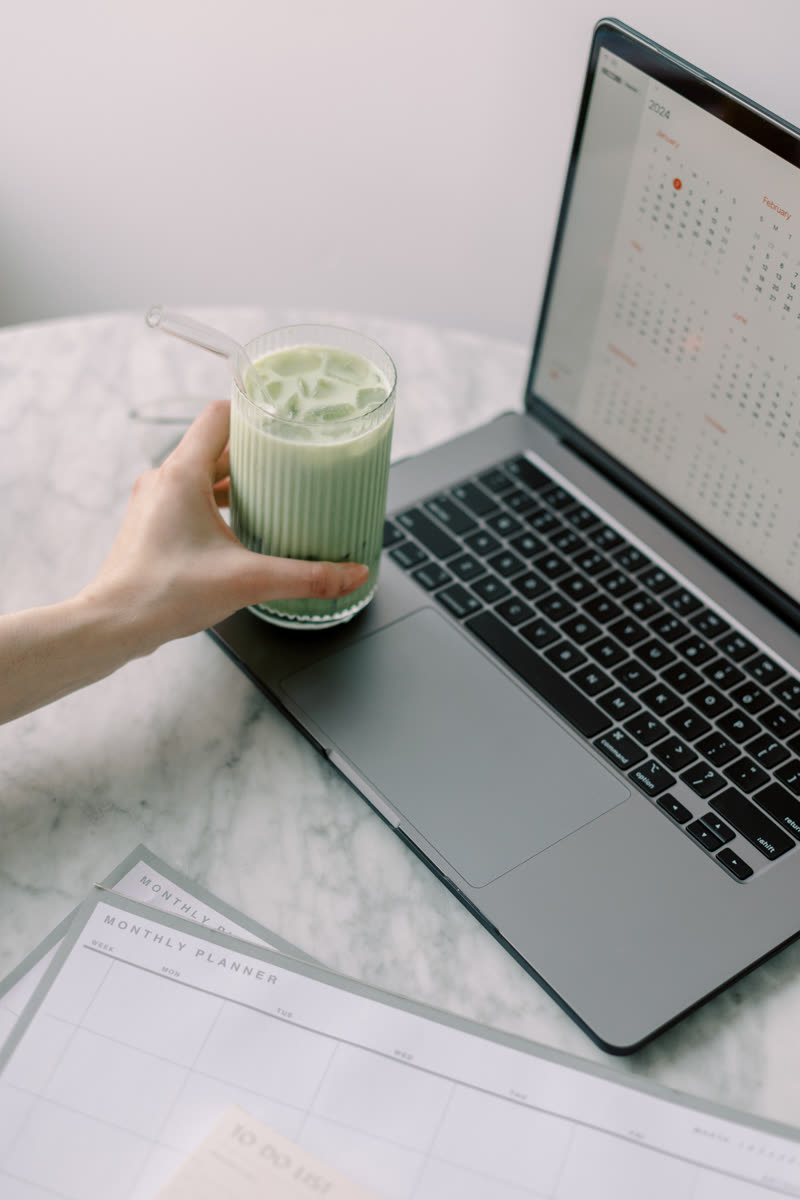 Hands cradling a cup of matcha